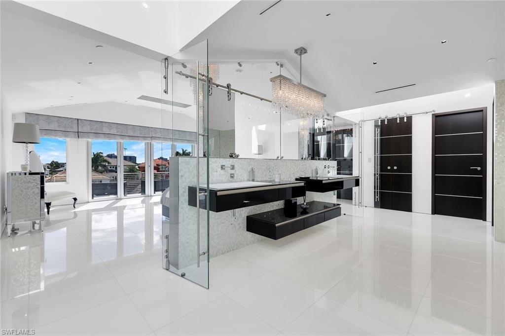 260 Channel Drive Naples, FL 34108 - Photo 20 of 48 a kitchen with stainless steel appliances kitchen island granite countertop a refrigerator and stove