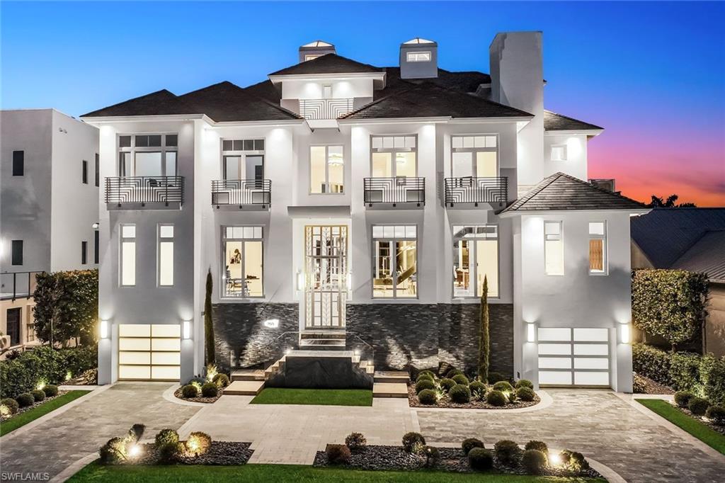 260 Channel Drive Naples, FL 34108 - Photo 2 of 48 a front view of a house with a yard