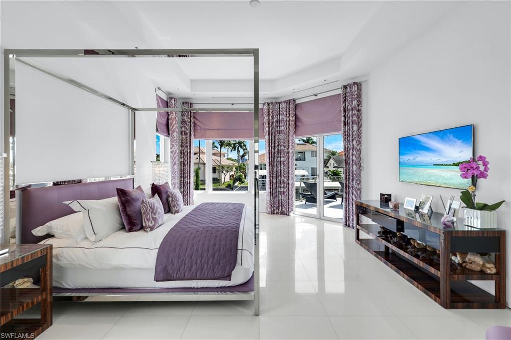 260 Channel Drive Naples, FL 34108 - Photo 24 of 48 a living room with furniture and a flat screen tv