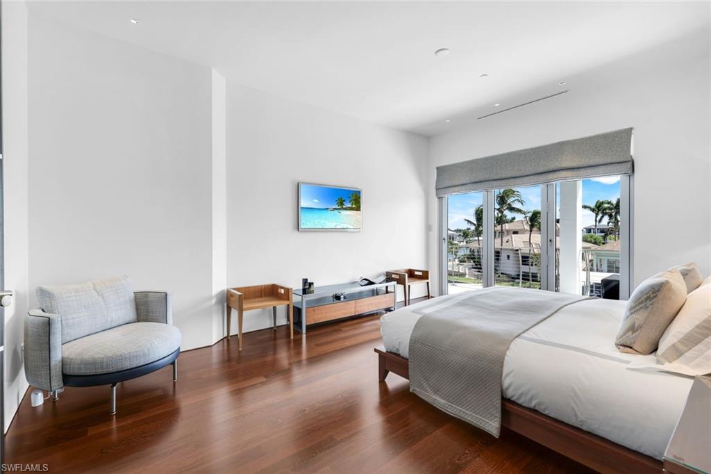 260 Channel Drive Naples, FL 34108 - Photo 26 of 48 a bedroom with a bed and a chair