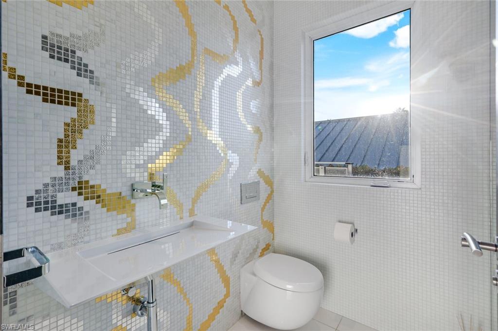 260 Channel Drive Naples, FL 34108 - Photo 34 of 48 a bathroom with a sink toilet and mirror