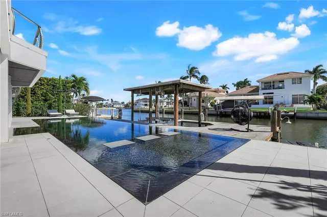 a view of a patio with swimming pool table and chairs