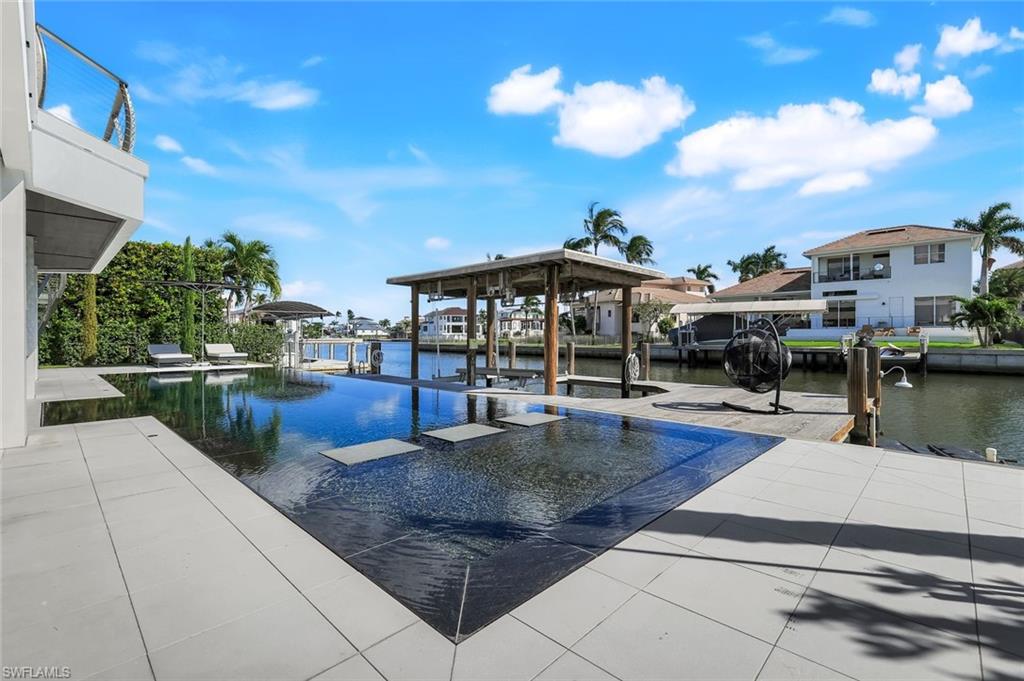 260 Channel Drive Naples, FL 34108 - Photo 39 of 48 a view of a swimming pool with a patio
