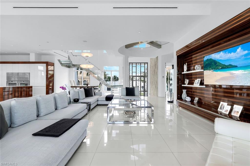 260 Channel Drive Naples, FL 34108 - Photo 6 of 48 a living room with furniture and a flat screen tv