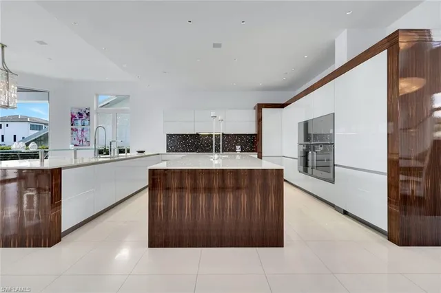 a kitchen with stainless steel appliances kitchen island granite countertop a stove a sink and a refrigerator