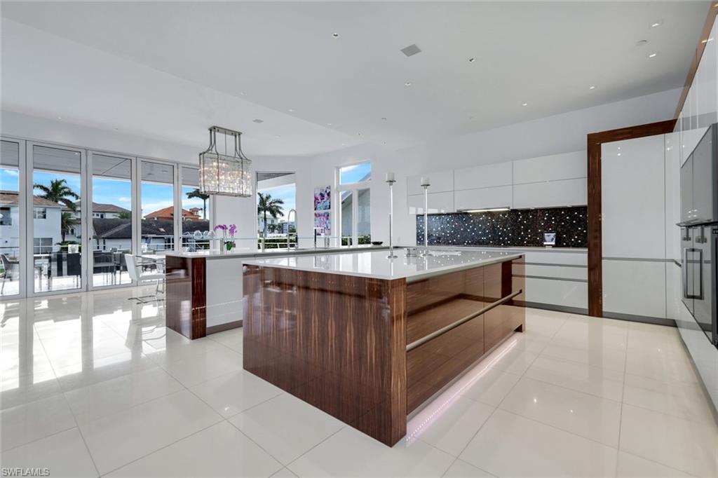260 Channel Drive Naples, FL 34108 - Photo 9 of 48 a kitchen with kitchen island cabinets and a sink