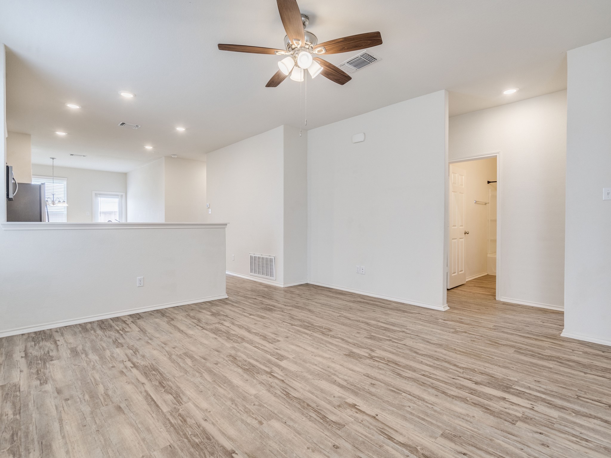 790 Pepperbark Loop Buda, TX 78610 - Photo 4 of 22 An inviting common area features a ceiling fan and contemporary flooring.