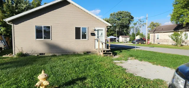 a view of a house with backyard and sitting area