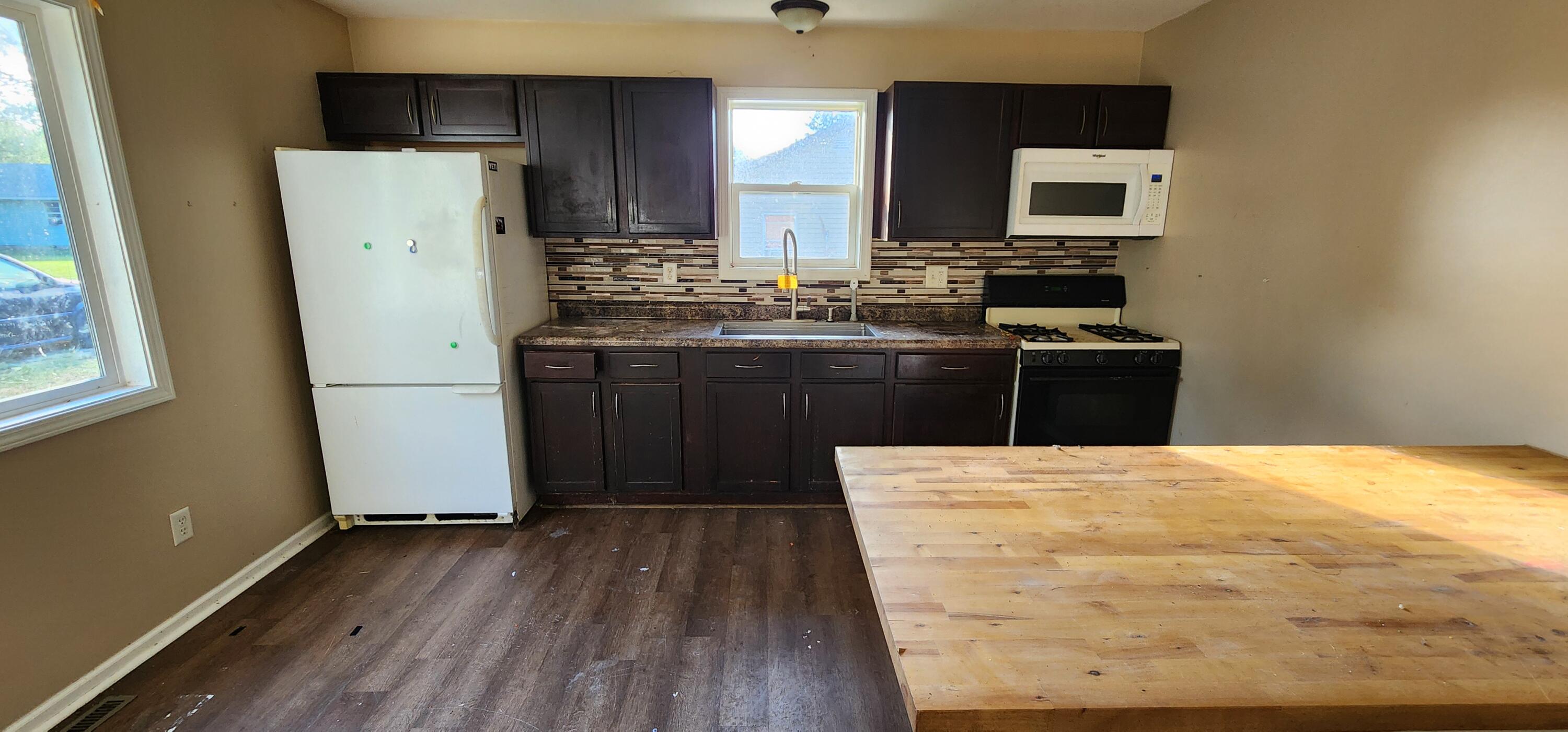 630 East Elm Street Rensselaer, IN 47978 - Photo 4 of 14 a kitchen with stainless steel appliances a refrigerator stove and sink