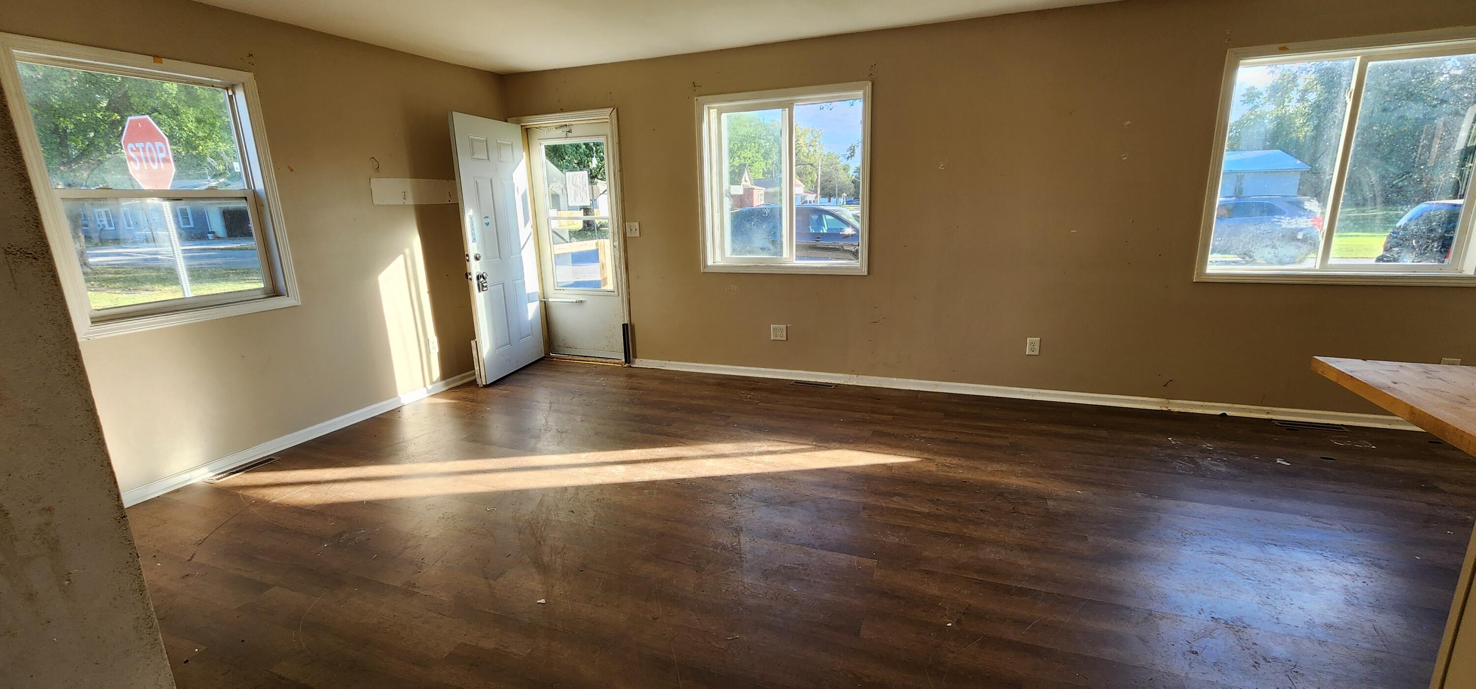 630 East Elm Street Rensselaer, IN 47978 - Photo 5 of 14 a view of an empty room with wooden floor and a window
