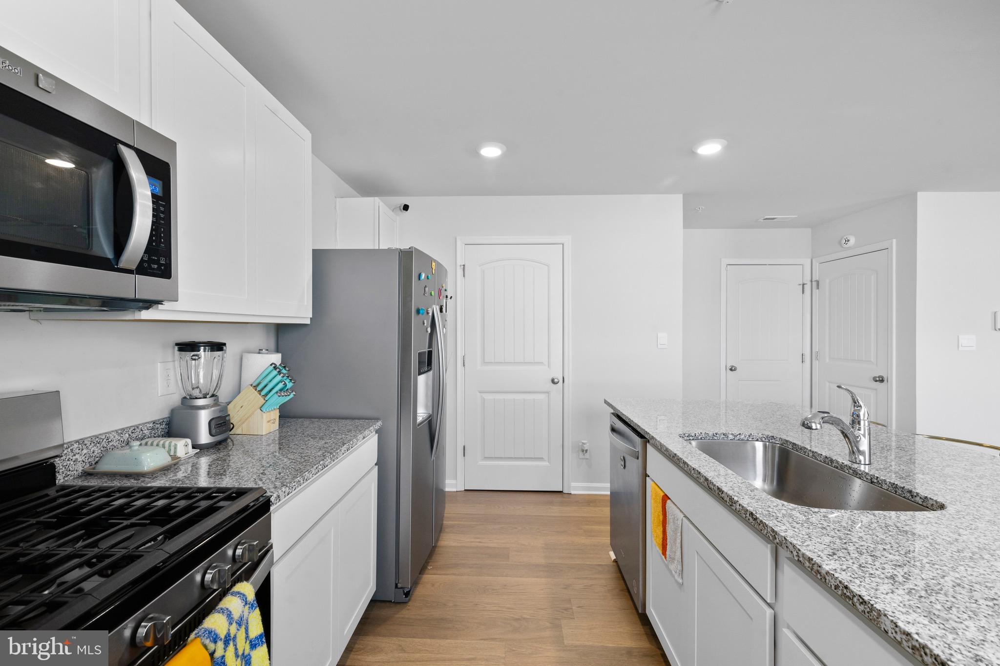 1638 Terrapin Circle Cambridge, MD 21613 - Photo 11 of 25 a kitchen with granite countertop stainless steel appliances a sink a stove and cabinets