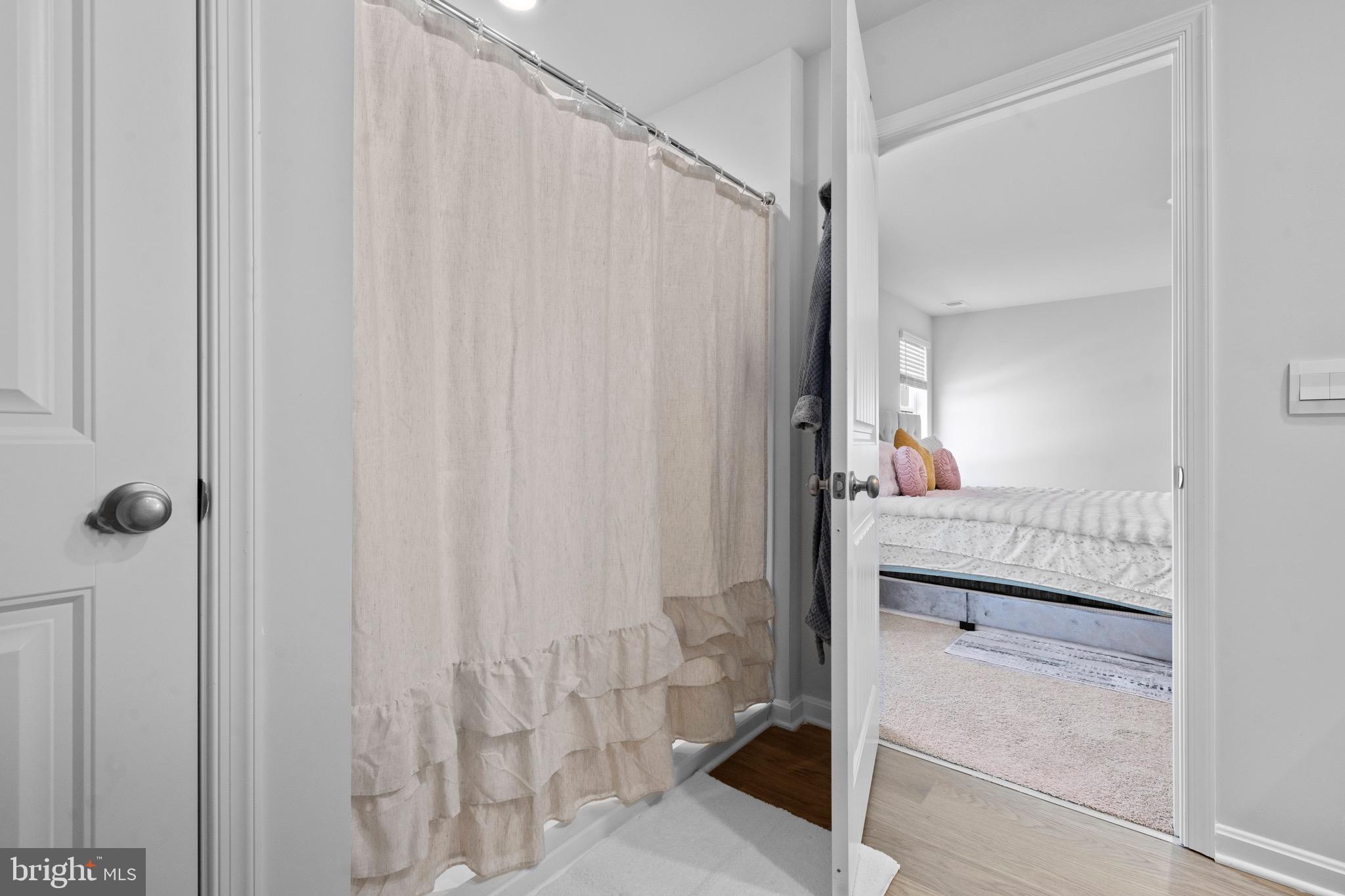 1638 Terrapin Circle Cambridge, MD 21613 - Photo 22 of 25 a bathroom with a shower curtain and a sink