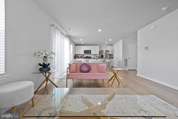 1638 Terrapin Circle Cambridge, MD 21613 - Photo 7 of 25 a living room with kitchen island furniture and a chandelier