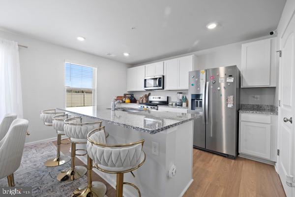 1638 Terrapin Circle Cambridge, MD 21613 - Photo 8 of 25 a kitchen with granite countertop a refrigerator and a stove top oven