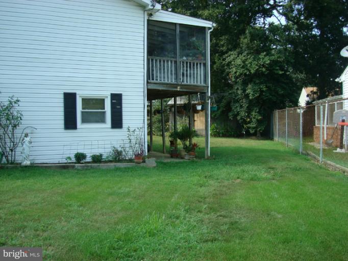 1627 Bay Ridge Road Edgewater, MD 21037 - Photo 10 of 21 a front view of a house with a garden