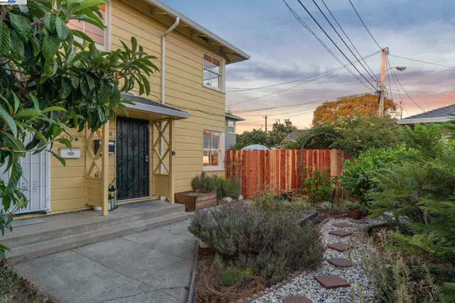 a view of a house with a small yard and plants
