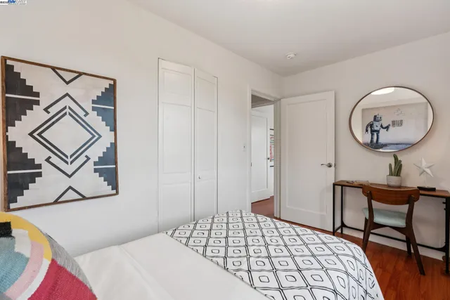 a bedroom with a bed a desk and chair