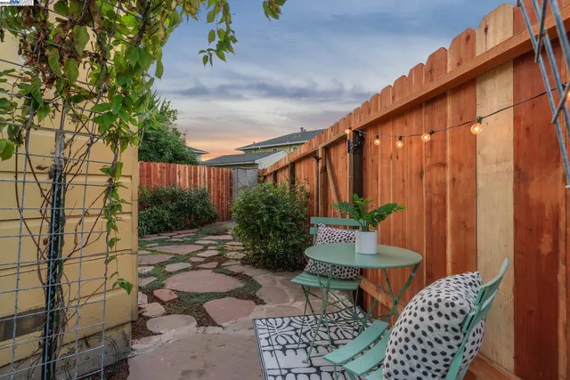 a backyard of a house with table and chairs