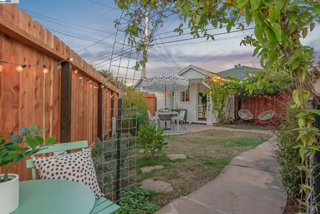 a view of a chair and table in backyard