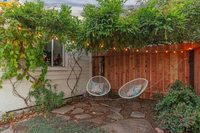a backyard of a house with table and chairs