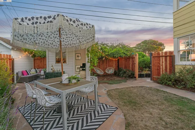 a view of a patio with table and chairs potted plants