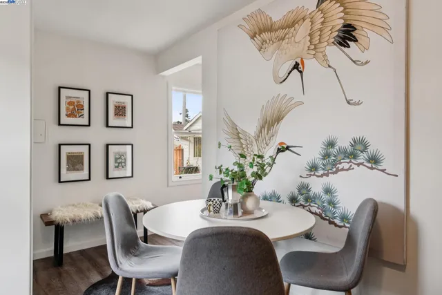 a dining room with furniture and wooden floor