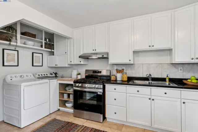 a kitchen with cabinets stainless steel appliances and a sink