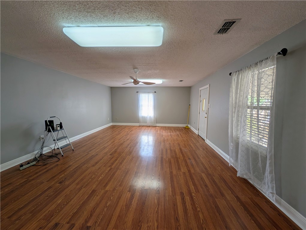 3561 Monterrey Street Corpus Christi, TX 78411 - Photo 11 of 21 a room with wooden floor and windows