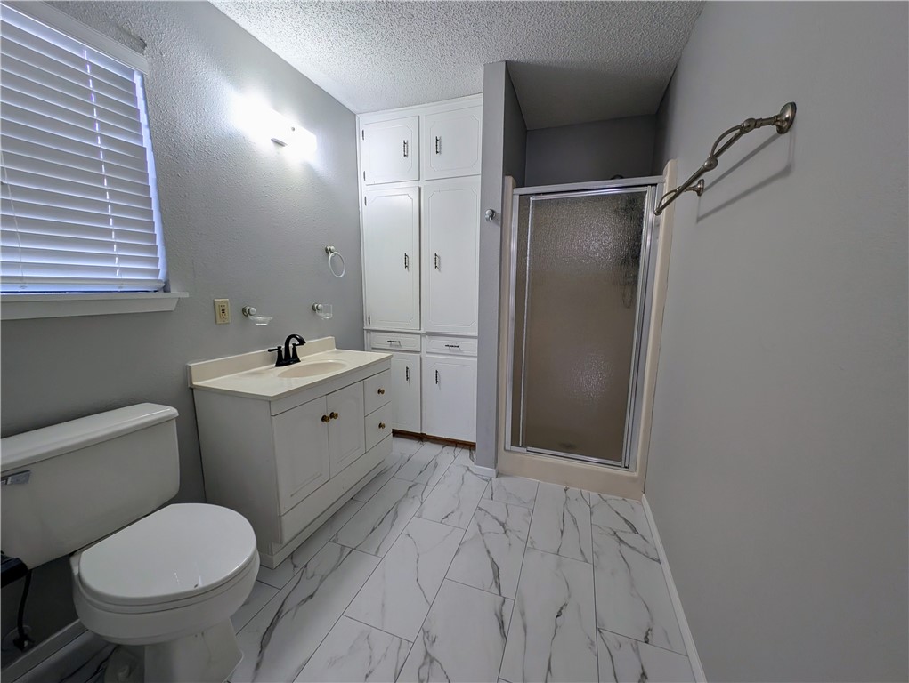 3561 Monterrey Street Corpus Christi, TX 78411 - Photo 12 of 21 a bathroom with a sink toilet and shower