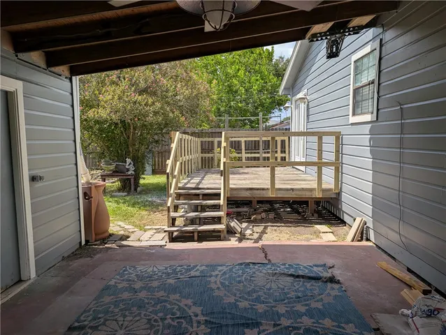a view of a backyard with plants and a patio