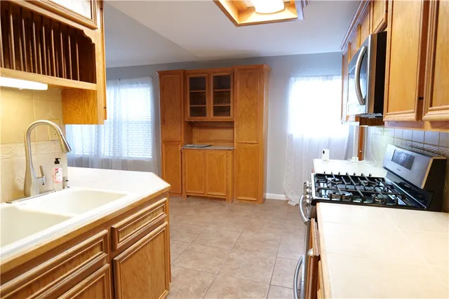 a kitchen with a refrigerator and a sink