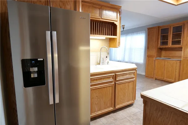 a kitchen with stainless steel appliances granite countertop a refrigerator a stove and a sink with dishwasher