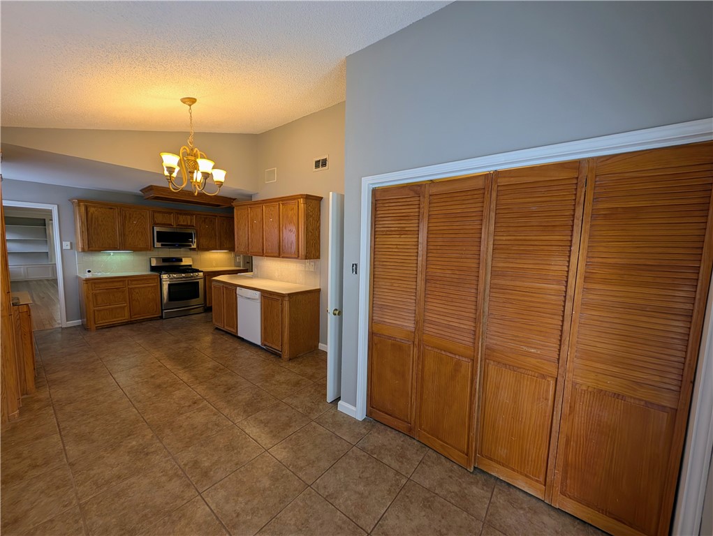 3561 Monterrey Street Corpus Christi, TX 78411 - Photo 9 of 21 a large kitchen with a refrigerator and a stove top oven