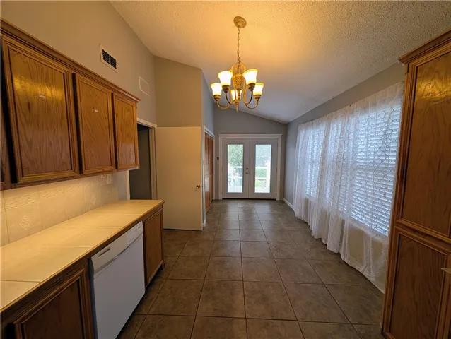 a room with wooden floor and windows