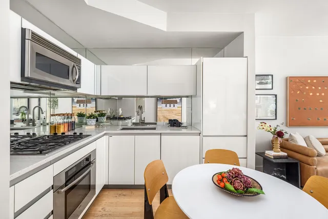 a bedroom with a bed and large windows