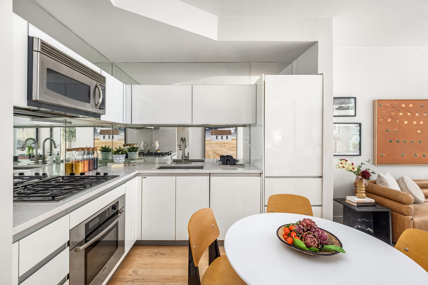 425 East 13th Street, Unit 2B Manhattan, NY 10009 - Photo 10 of 17 a kitchen with a sink a stove and cabinets