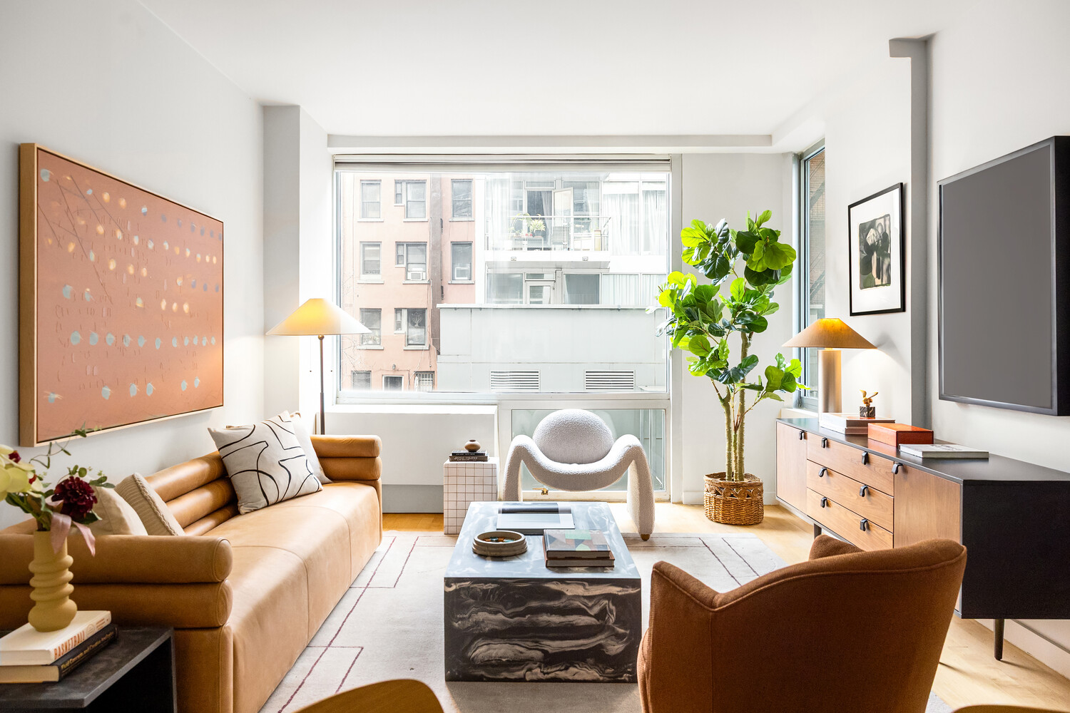 425 East 13th Street, Unit 2B Manhattan, NY 10009 - Photo 3 of 17 a living room with furniture and a large window