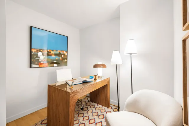 a bedroom with a bed and a couch next to a window