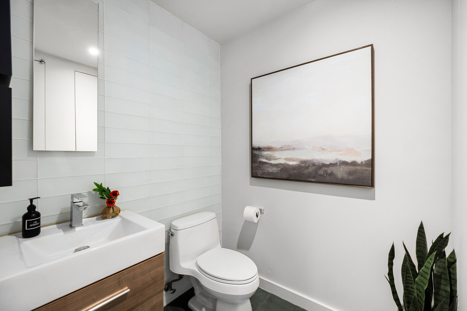 425 East 13th Street, Unit 2B Manhattan, NY 10009 - Photo 7 of 17 a bathroom with a sink mirror and toilet