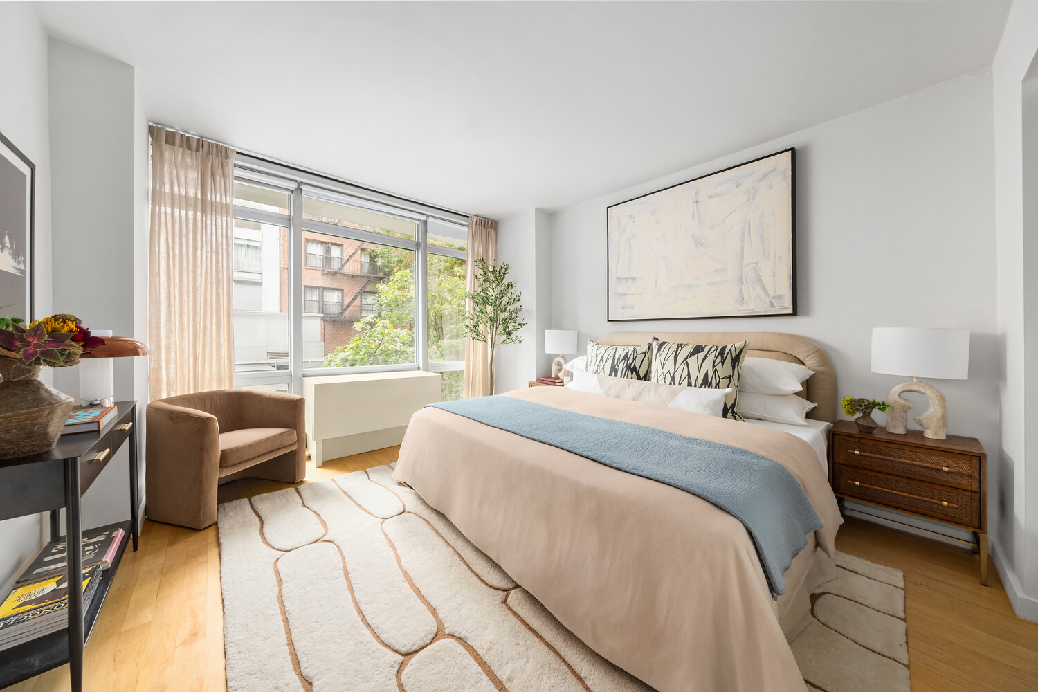 425 East 13th Street, Unit 2B Manhattan, NY 10009 - Photo 9 of 17 a bedroom with a bed and large windows