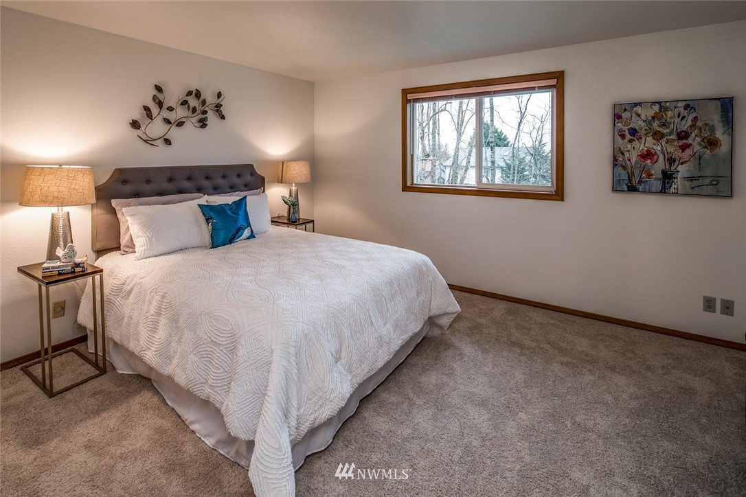 1404 Welling Road Bellingham, WA 98226 - Photo 12 of 21 a bedroom with a large bed and a chandelier