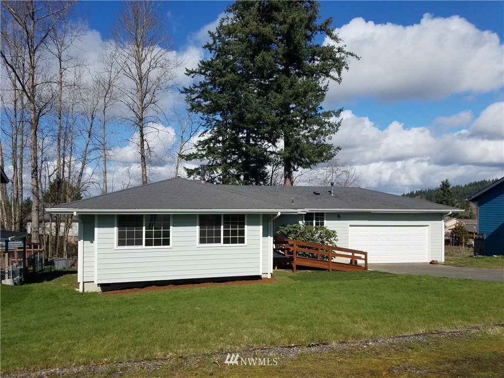1404 Welling Road Bellingham, WA 98226 - Photo 21 of 21 a view of a white house with a big yard and large trees
