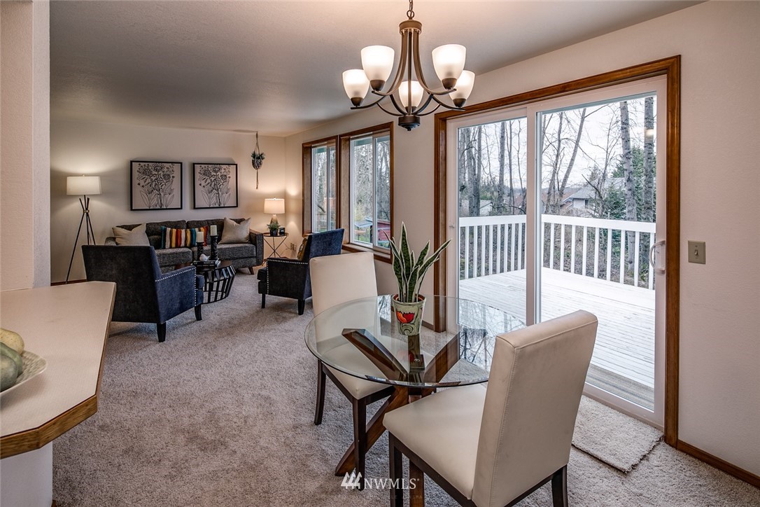 1404 Welling Road Bellingham, WA 98226 - Photo 6 of 21 a view of a dining room with furniture wooden floor and chandelier