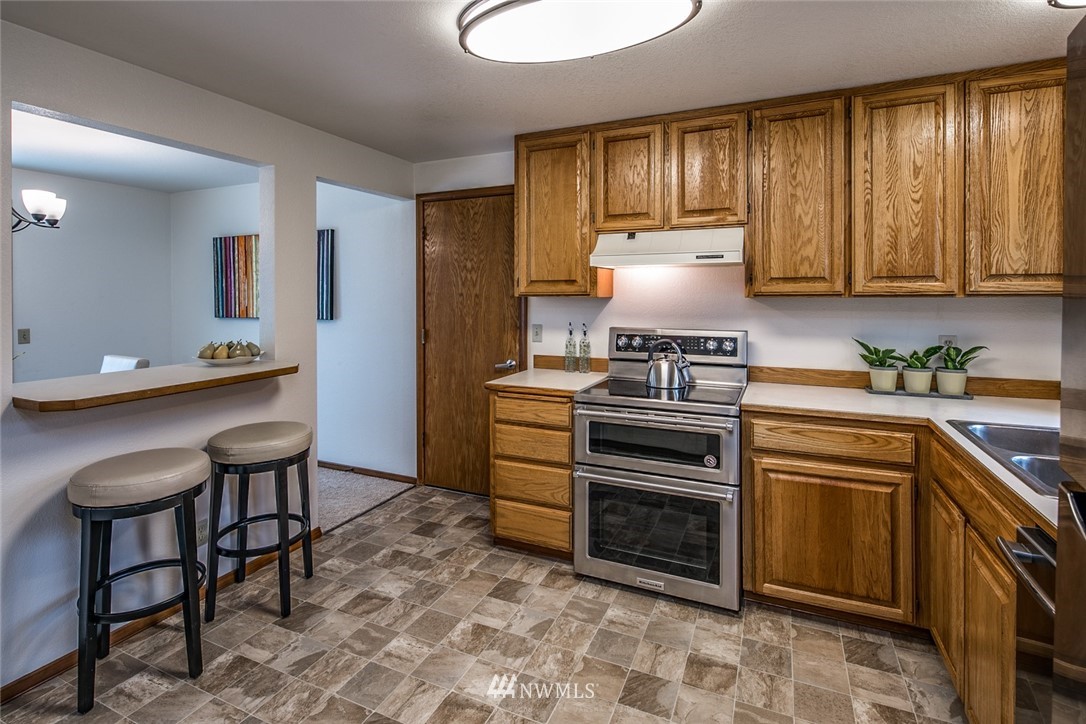 1404 Welling Road Bellingham, WA 98226 - Photo 9 of 21 a kitchen with a stove a sink and a refrigerator