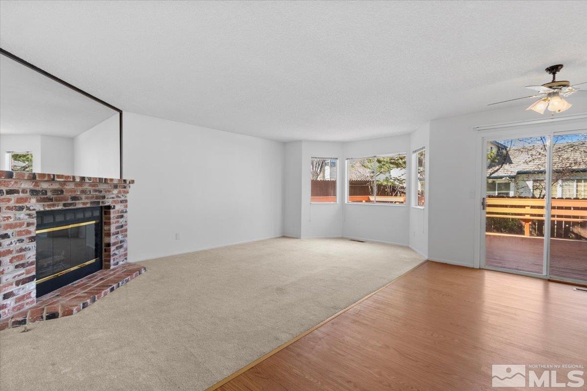 989 Ridgeview Drive Reno, NV 89511 - Photo 10 of 20 a view of an empty room with window and fireplace