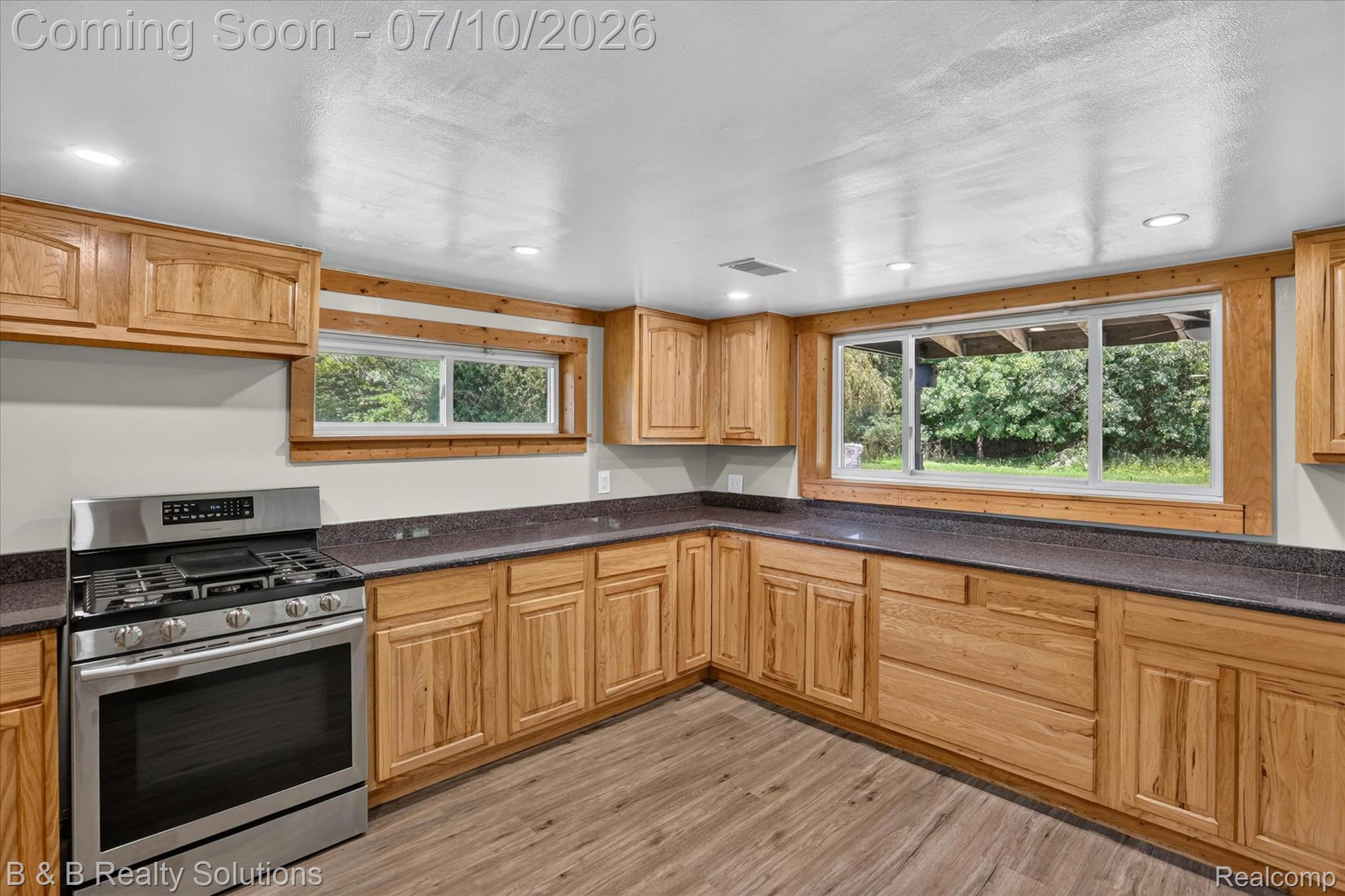 1564 East Burnside Road North Branch, MI 48461 - Photo 4 of 25 Kitchen featuring wood-finish cabinetry, dark countertops, a stainless steel range, wood-finish flooring, and recessed lighting
