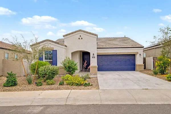 front view of a house with a yard and a garage