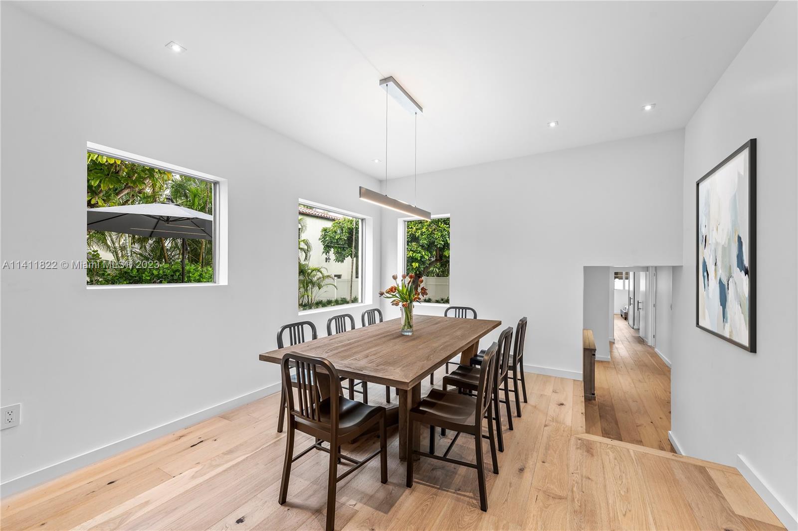 5956 Pine Tree Drive Miami Beach, FL 33140 - Photo 11 of 55 a view of a dining room with furniture window and wooden floor