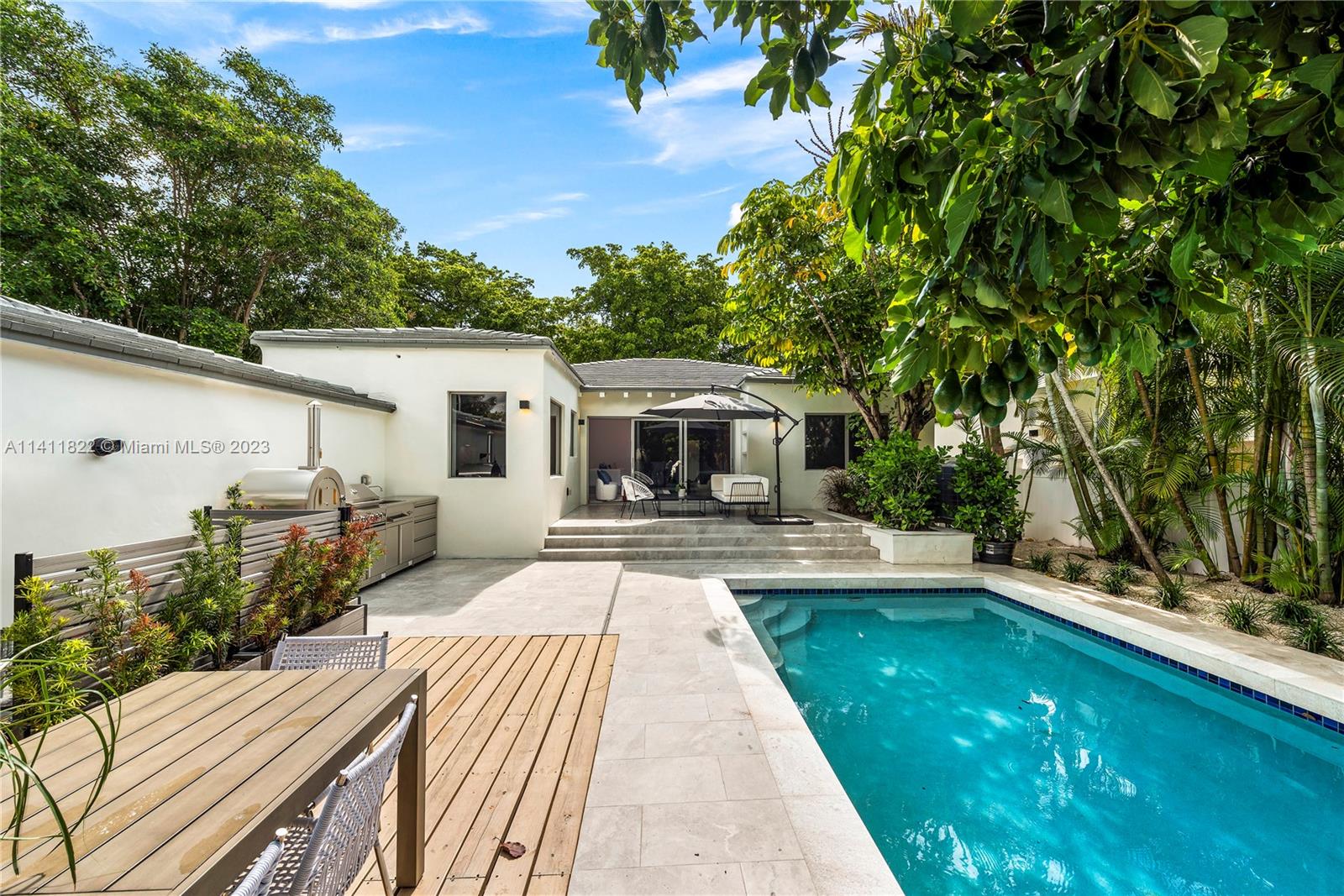 5956 Pine Tree Drive Miami Beach, FL 33140 - Photo 13 of 55 a front view of a house with yard patio and green space