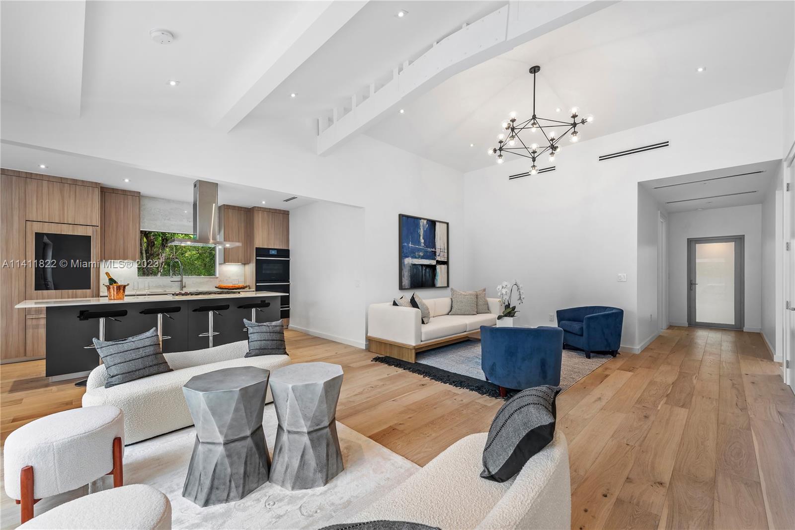 5956 Pine Tree Drive Miami Beach, FL 33140 - Photo 2 of 55 a living room with furniture and a chandelier